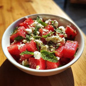 Bowl of watermelon feta salad with fresh mint, a light and refreshing summer dish.
