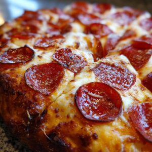 A close-up, mouth-watering view of a freshly baked homemade pepperoni pizza with melted cheese and crispy pepperoni slices.